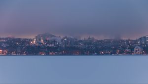 Preview wallpaper coast, city, buildings, clouds, dusk