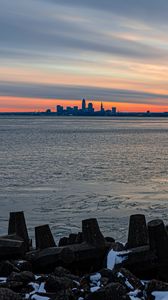 Preview wallpaper coast, city, water, ice, sunset