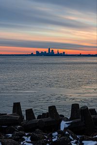 Preview wallpaper coast, city, water, ice, sunset