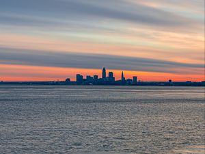 Preview wallpaper coast, city, water, ice, sunset