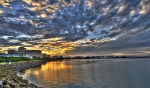 Preview wallpaper coast, clouds, city, morning, road, structures