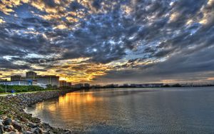 Preview wallpaper coast, clouds, city, morning, road, structures