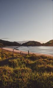 Preview wallpaper coast, hills, sea, stairs, grass, sky