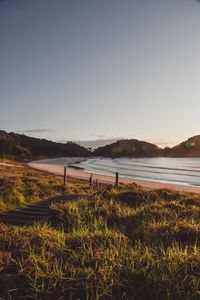 Preview wallpaper coast, hills, sea, stairs, grass, sky