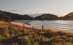 Preview wallpaper coast, hills, sea, stairs, grass, sky