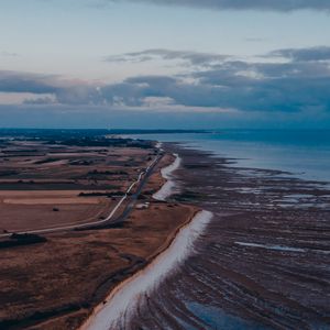 Preview wallpaper coast, horizon, road, sea, field