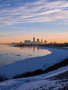 Preview wallpaper coast, lake, winter, snow, city, sunrise