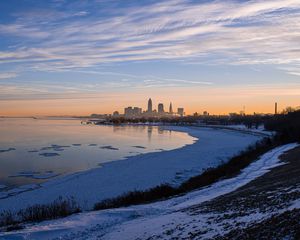 Preview wallpaper coast, lake, winter, snow, city, sunrise