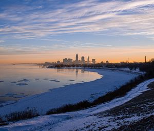 Preview wallpaper coast, lake, winter, snow, city, sunrise