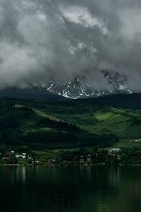 Preview wallpaper coast, mountains, buildings, fog