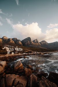 Preview wallpaper coast, mountains, rocks, water, buildings