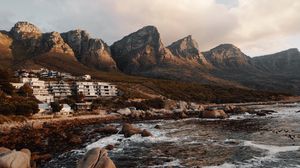 Preview wallpaper coast, mountains, rocks, water, buildings
