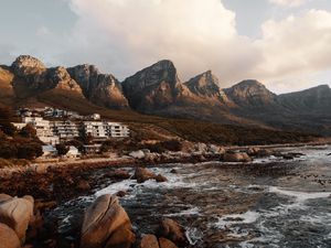 Preview wallpaper coast, mountains, rocks, water, buildings