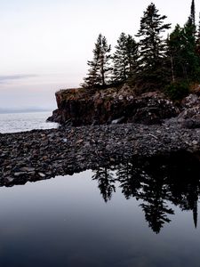 Preview wallpaper coast, pebbles, rock, trees