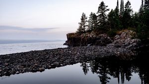 Preview wallpaper coast, pebbles, rock, trees