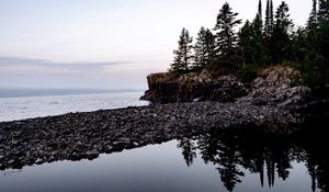Preview wallpaper coast, pebbles, rock, trees