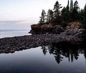 Preview wallpaper coast, pebbles, rock, trees