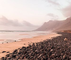 Preview wallpaper coast, pebbles, rocks, sea