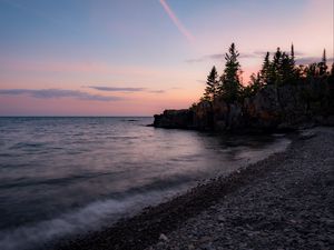 Preview wallpaper coast, pebbles, sea, trees, twilight