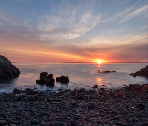 Preview wallpaper coast, pebbles, stones, sea, sunset