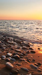 Preview wallpaper coast, pebbles, stones, sea, nature, sunset