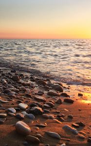 Preview wallpaper coast, pebbles, stones, sea, nature, sunset