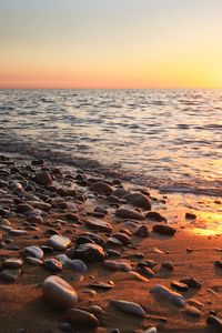 Preview wallpaper coast, pebbles, stones, sea, nature, sunset