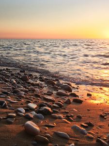 Preview wallpaper coast, pebbles, stones, sea, nature, sunset