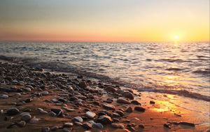 Preview wallpaper coast, pebbles, stones, sea, nature, sunset