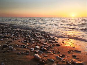 Preview wallpaper coast, pebbles, stones, sea, nature, sunset