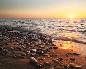 Preview wallpaper coast, pebbles, stones, sea, nature, sunset