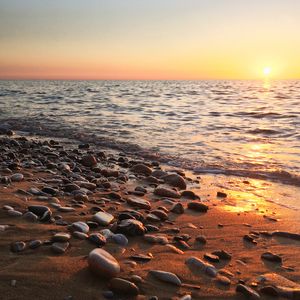 Preview wallpaper coast, pebbles, stones, sea, nature, sunset