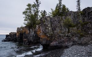 Preview wallpaper coast, rock, trees, sea, pebbles, nature