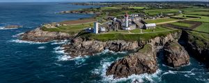 Preview wallpaper coast, rocks, buildings, sea, waves