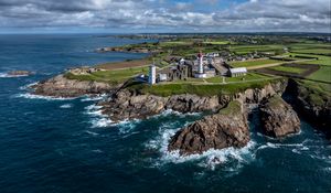 Preview wallpaper coast, rocks, buildings, sea, waves