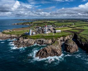 Preview wallpaper coast, rocks, buildings, sea, waves