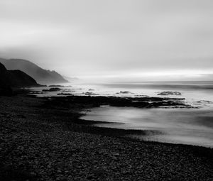 Preview wallpaper coast, rocks, fog, black and white