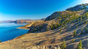 Preview wallpaper coast, rocks, hills, lake, sky