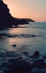 Preview wallpaper coast, rocks, sea, stones, dusk