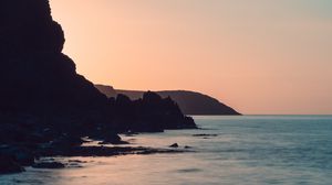 Preview wallpaper coast, rocks, sea, stones, dusk
