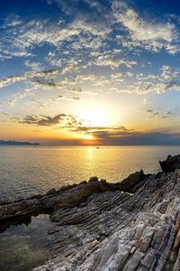 Preview wallpaper coast, rocks, sea, horizon, sun, sunset