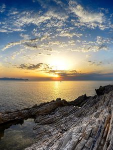 Preview wallpaper coast, rocks, sea, horizon, sun, sunset