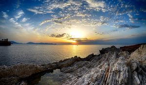 Preview wallpaper coast, rocks, sea, horizon, sun, sunset