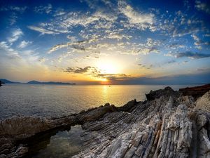 Preview wallpaper coast, rocks, sea, horizon, sun, sunset