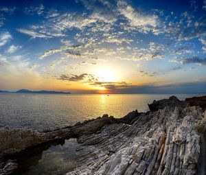 Preview wallpaper coast, rocks, sea, horizon, sun, sunset