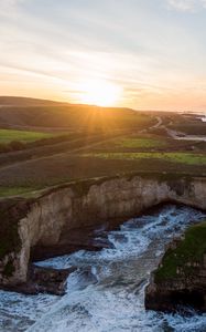 Preview wallpaper coast, rocks, sea, water, sun, landscape, aerial view