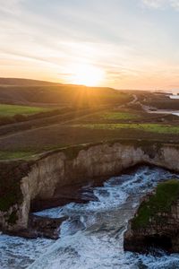 Preview wallpaper coast, rocks, sea, water, sun, landscape, aerial view