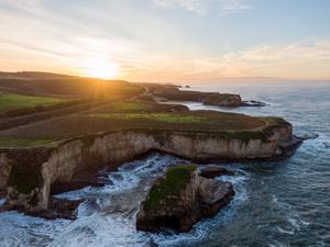 Preview wallpaper coast, rocks, sea, water, sun, landscape, aerial view