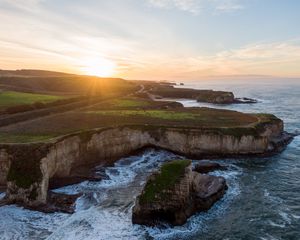 Preview wallpaper coast, rocks, sea, water, sun, landscape, aerial view