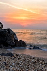 Preview wallpaper coast, rocks, sea, water, waves, sunset